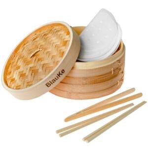 Bamboo steamer basket with lid, steaming dumplings and vegetables
